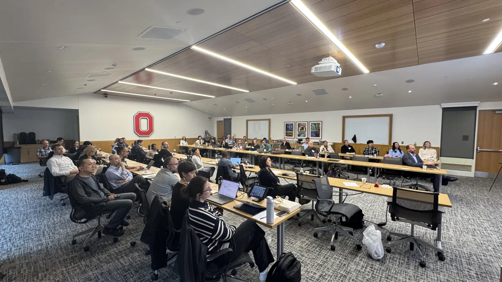 Attendees listen to a presentation at TDAI’s symposium on AI and social measurement.