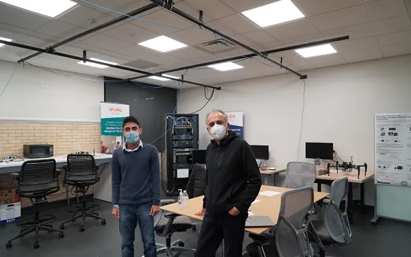 Dr. Anish Arora and a student in a TDAI lab in residence