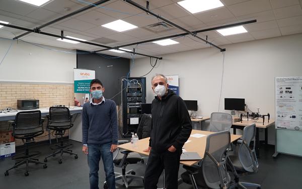 Dr. Anish Arora and a student in a TDAI lab in residence