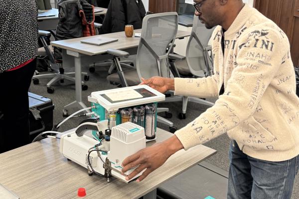 A workshop participant uses a LI-6800 portable photosynthesis system to measure leaf gas exchange during the TDAI-hosted LI-COR training in Pomerene Hall.