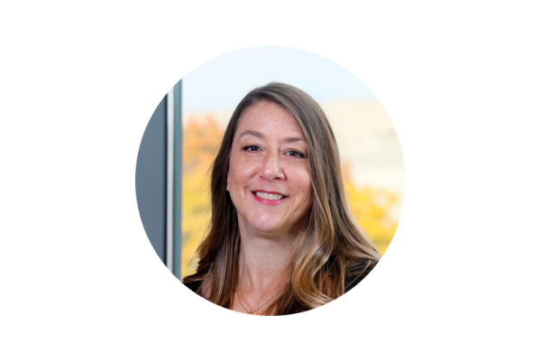 Kristina Markel, a professional headshot of a woman with a friendly expression, wearing business attire, photographed against a neutral background.