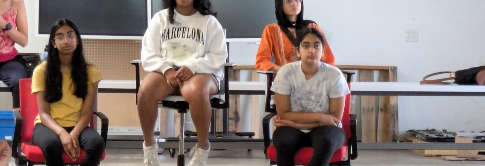 Summer camp students listening to presentations